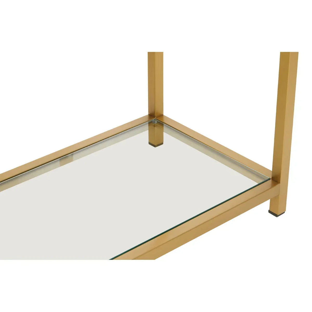 Gold metal frame coffee table with clear glass shelf, close-up of corner detail