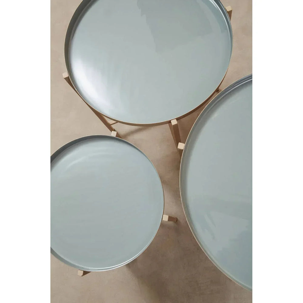 Set of three round nesting tables with light blue tops and wooden legs, top view