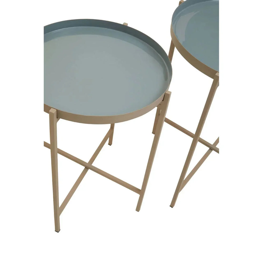 Set of two round metal tray tables with light blue tops and cream legs, side view