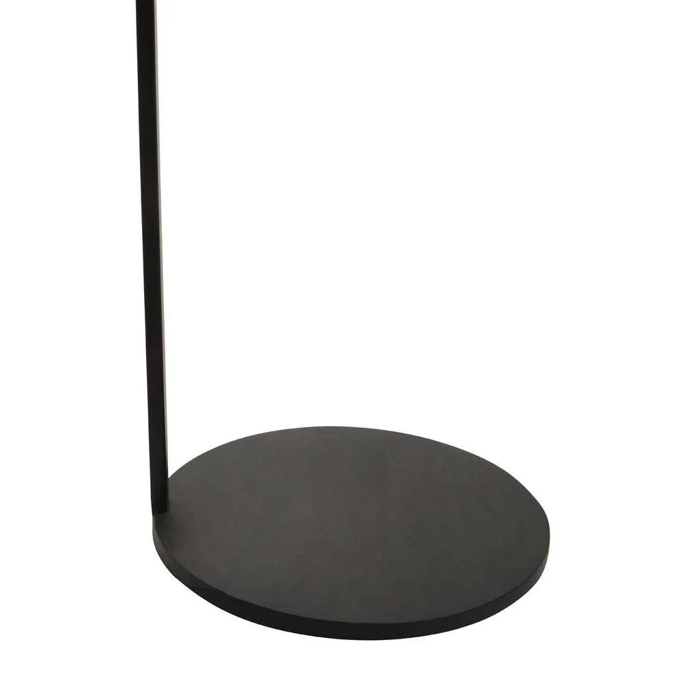 Round black metal base of a floor lamp with slim vertical pole