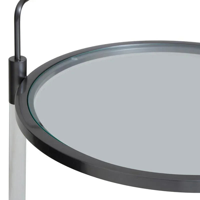 Round glass side table with black metal frame and handle, close-up top angle