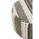 A close-up view of the Cefena grey and white stool, showcasing its textured fabric with geometric patterns in shades of grey, cream, and black. The stool has a rounded shape and features intricate stitching details