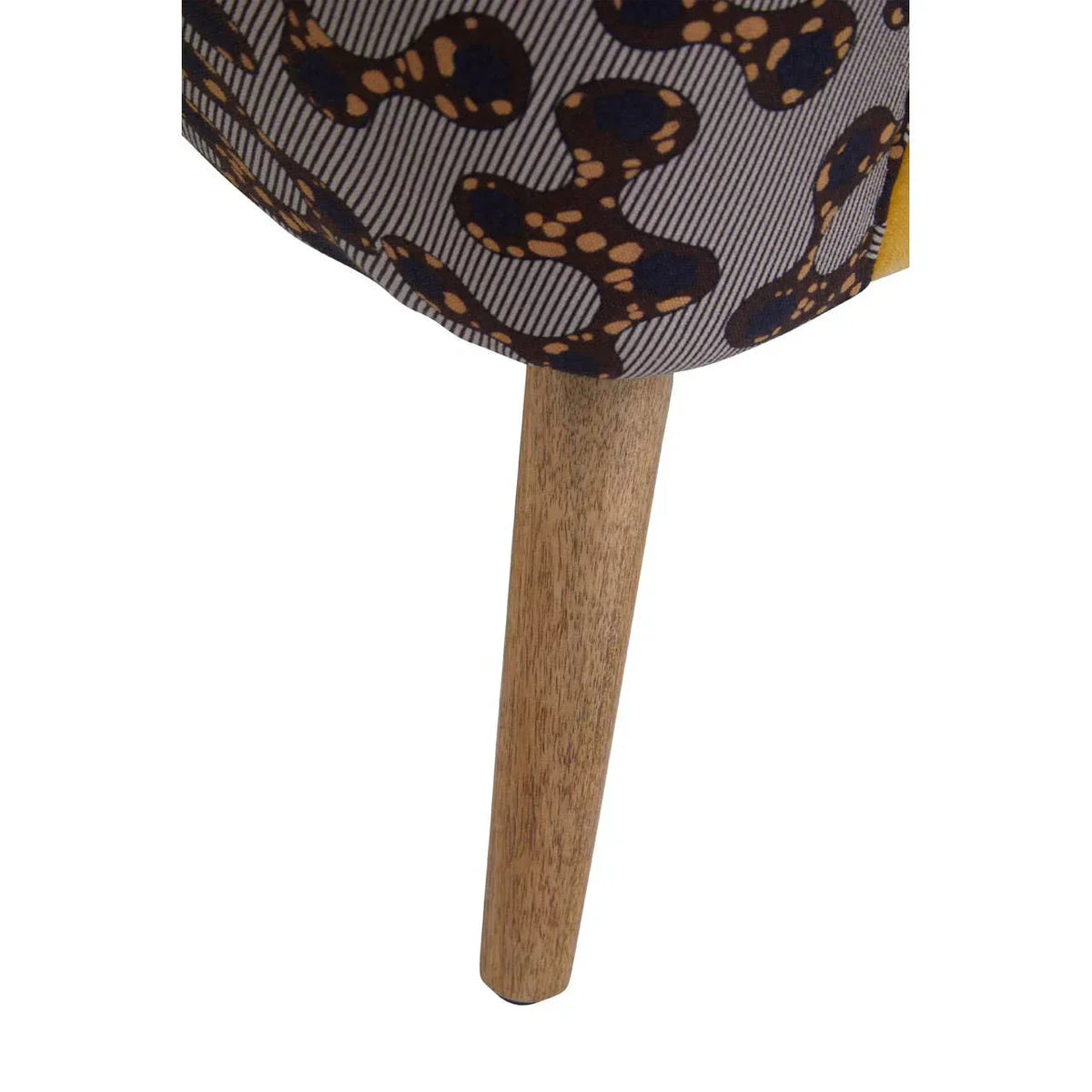 Upholstered furniture with patterned fabric and wooden tapered leg close-up