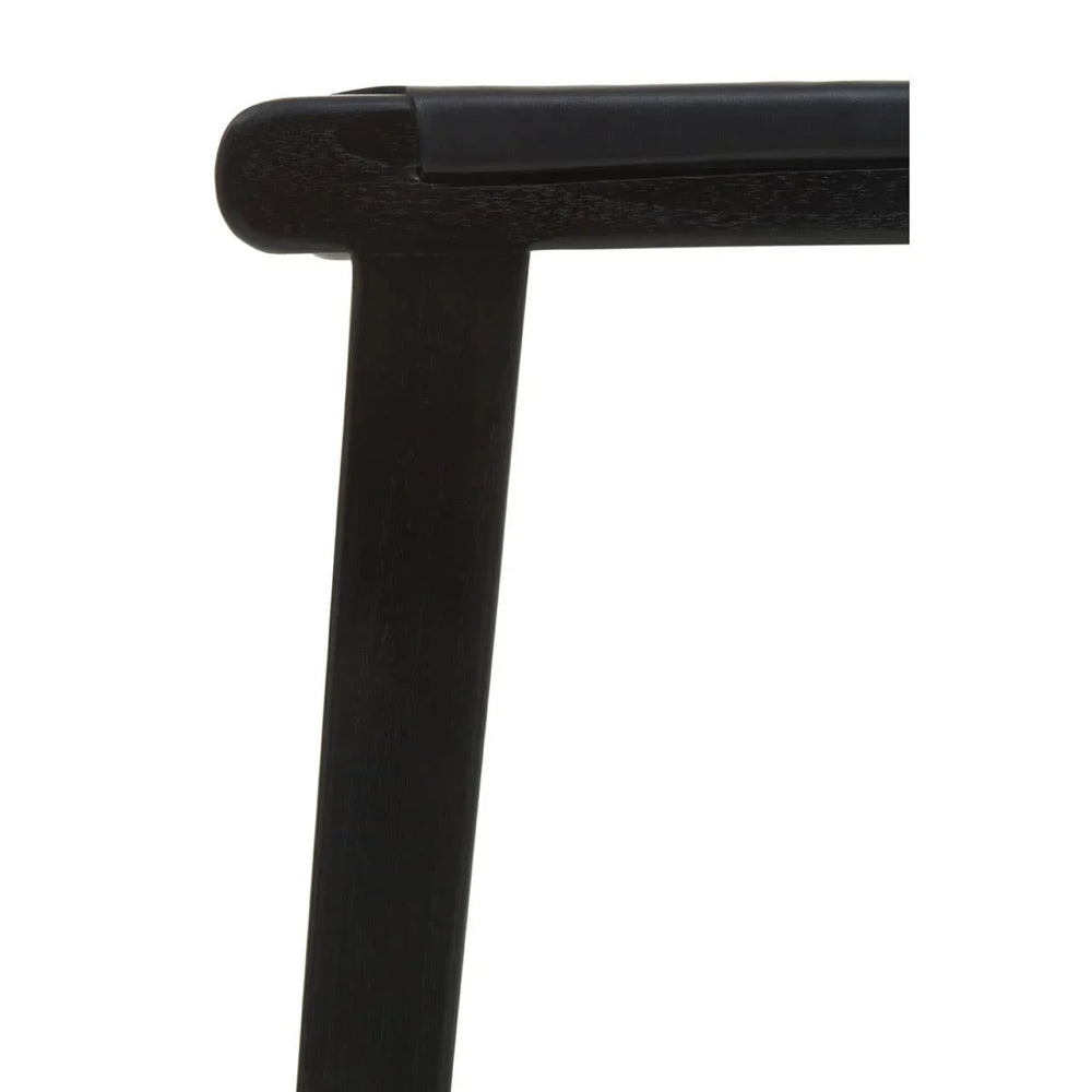 Close up of black wooden chair frame with smooth corner joint and upholstered seat edge