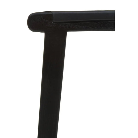 Close up of black wooden chair frame with smooth corner joint and upholstered seat edge