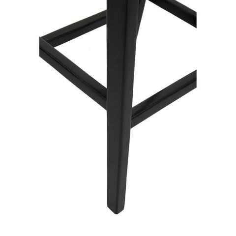 Black metal furniture leg with support bar, close-up view of modern stool base