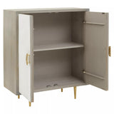 Cream and grey two-door cabinet made from mango wood, featuring a smooth finish, two doors with gold handles, and an open interior with one shelf. The cabinet stands on four gold legs, adding a modern touch to the design