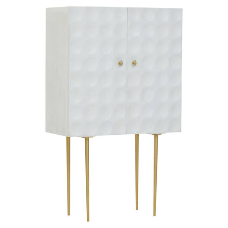 Cream finish two-door cabinet made of mango wood, featuring a textured geometric pattern on the front, supported by four slender gold legs. The cabinet has two round gold knobs for easy access to the storage space inside