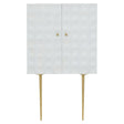 Cream finish two-door cabinet made from mango wood, featuring a textured front with a geometric pattern, gold knobs, and slender gold legs for support