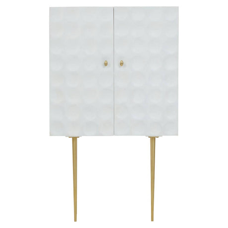 Cream finish two-door cabinet made from mango wood, featuring a textured front with a geometric pattern, gold knobs, and slender gold legs for support