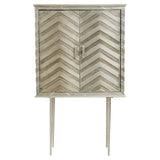 Two-door cabinet featuring a chevron pattern on the front, finished in a light color. The cabinet is elevated on slender legs and has a simple metal handle for opening the doors. The overall design is modern and stylish, suitable for home decor