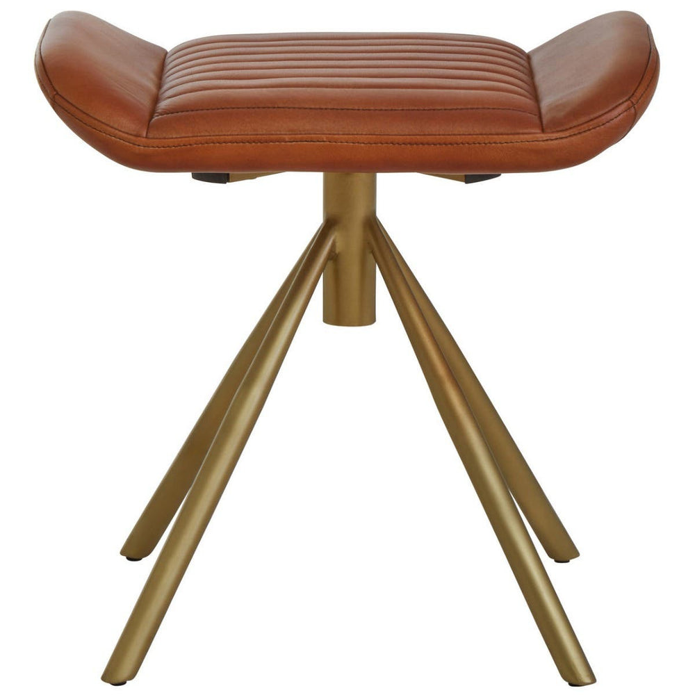 Buffalo tan leather footstool with a curved top and a sleek, modern design, supported by a sturdy, gold-colored tripod base