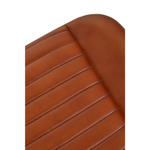Buffalo tan leather footstool featuring a smooth, rounded top with subtle stitching and a textured surface, showcasing a warm, rich color that adds a touch of elegance to any space