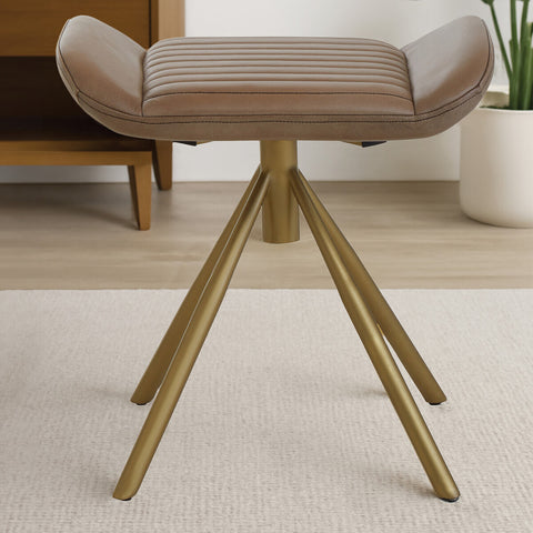 Buffalo grey leather footstool with a curved top and three angled wooden legs, set against a light-colored rug and a neutral background