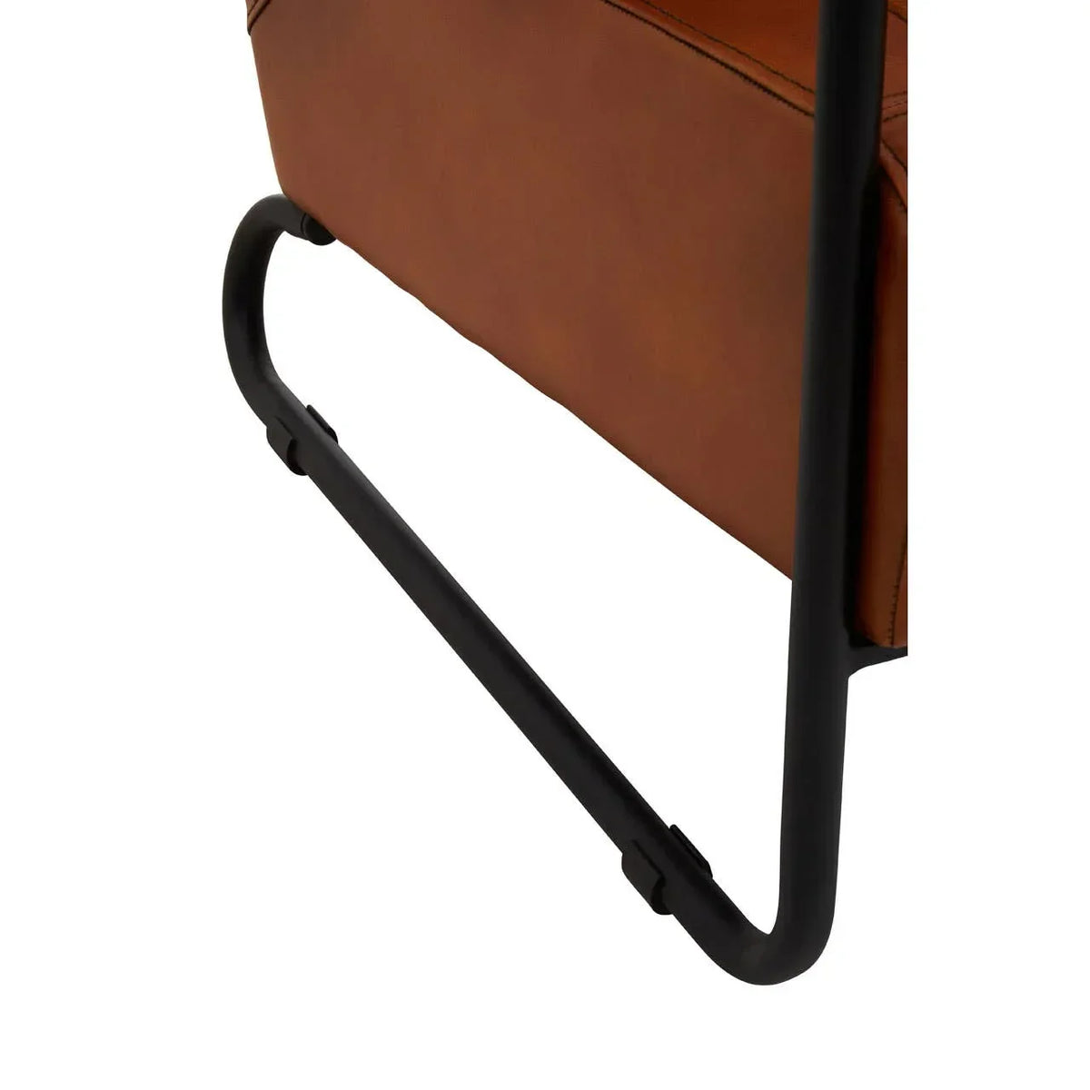 Brown leather chair with black metal cantilever leg close-up