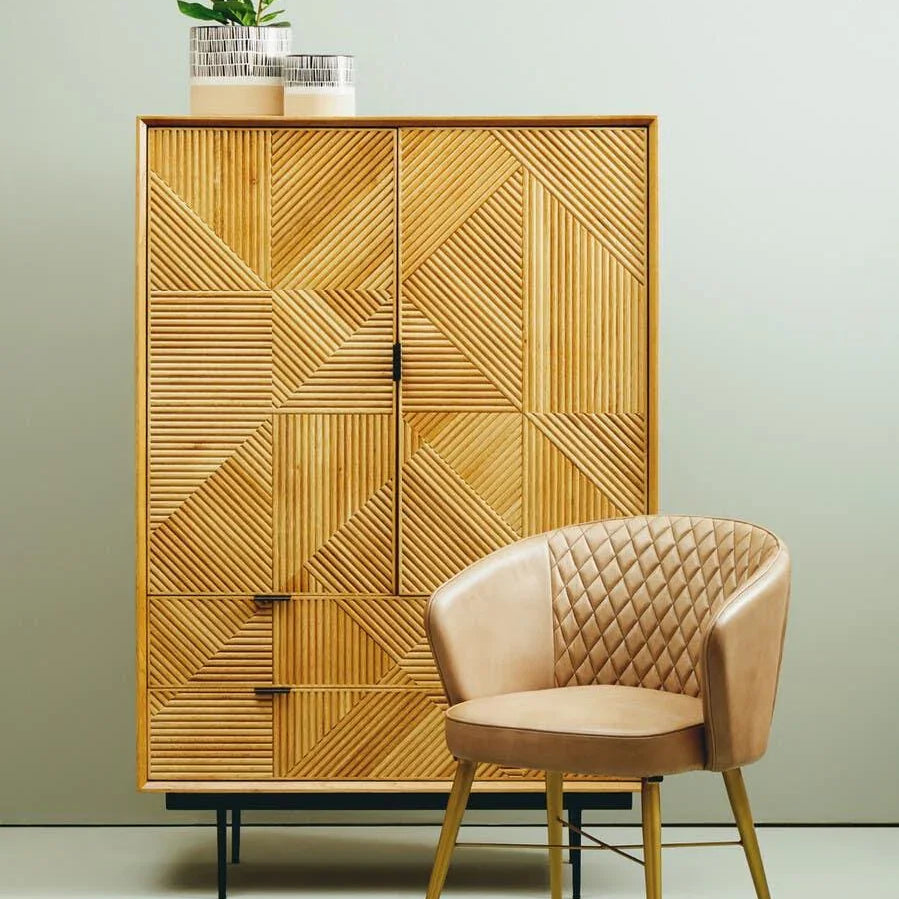 Geometric wood sideboard with metal legs and tan quilted dining chair in modern room