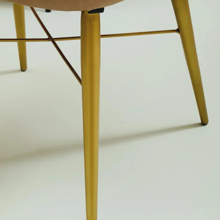 Beige dining chair with gold metal legs and supportive crossbar detail