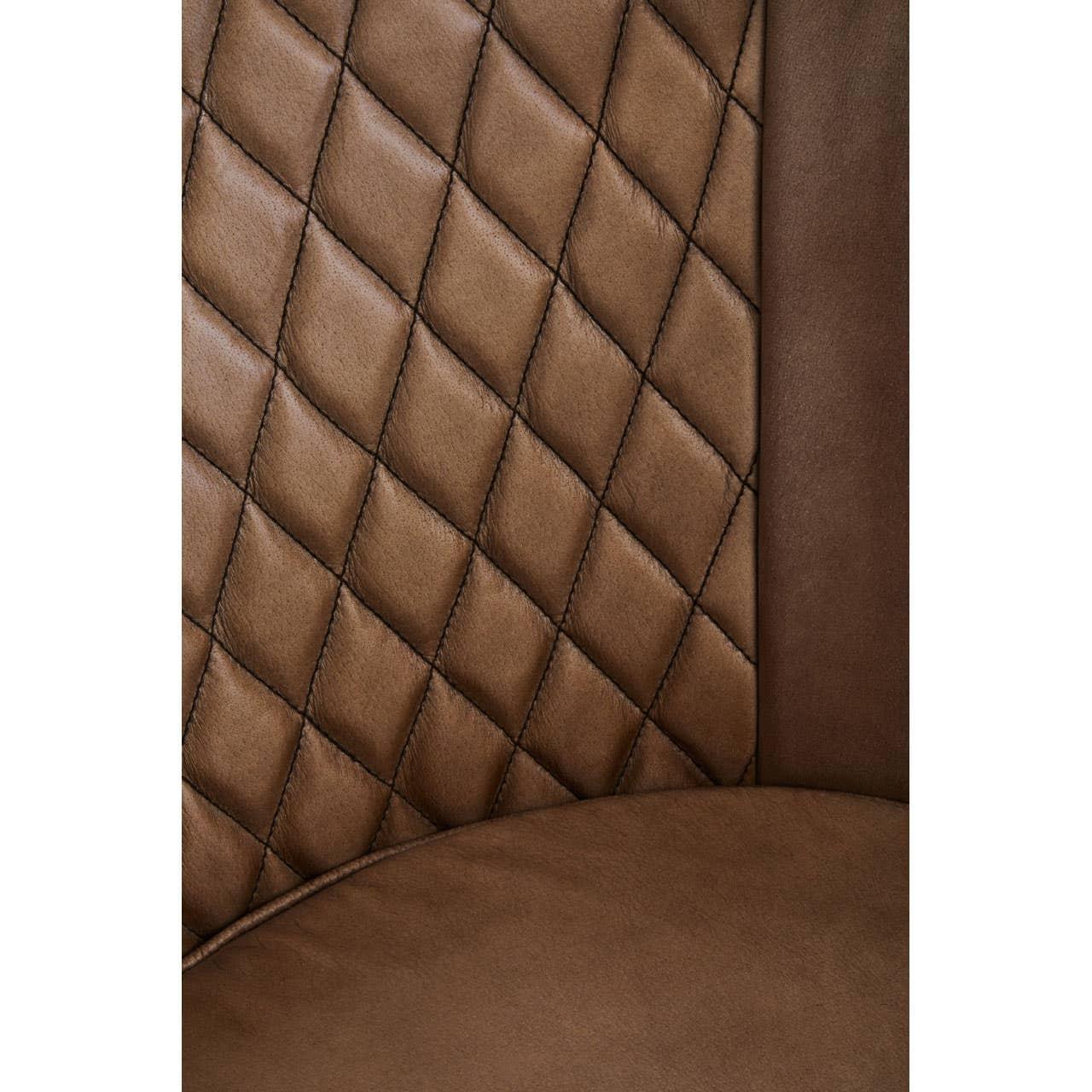 Brown faux leather chair with diamond quilted stitching on backrest