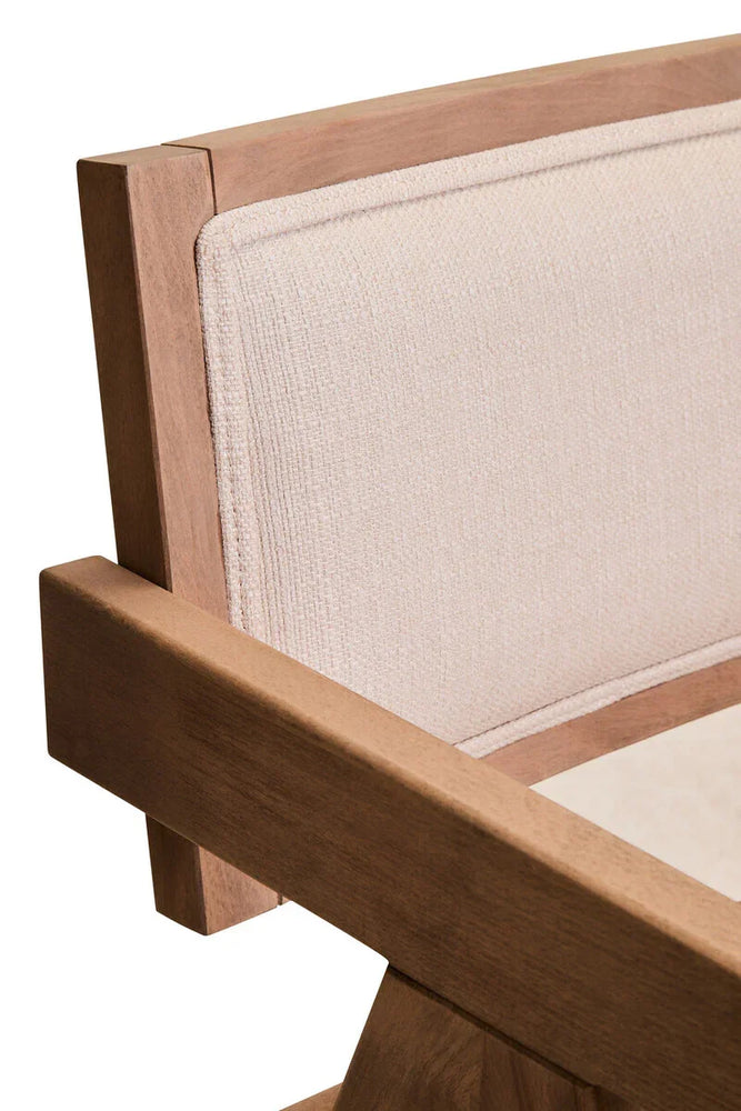Close-up of light wood armchair with beige upholstered fabric backrest