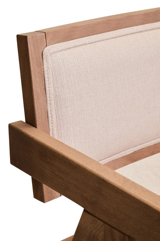 Close-up of light wood armchair with beige upholstered fabric backrest