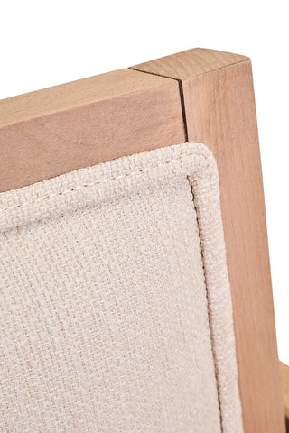 Light wood chair frame with beige upholstered backrest in close-up view