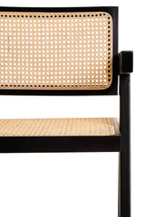 Black wood dining chair with woven cane seat and backrest, close-up angle