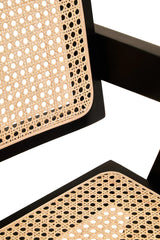 Close view of rattan dining chair seat and backrest with black wooden frame