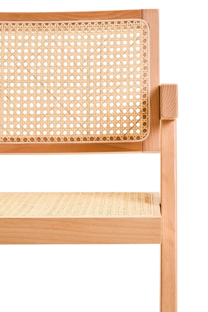 Closeup of natural wood dining chair with rattan seat and cane backrest