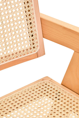 Close-up of natural wood cane chair showing woven rattan seat and backrest detail