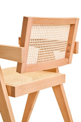 Close up of wooden armchair with natural cane seat and backrest, angled side view