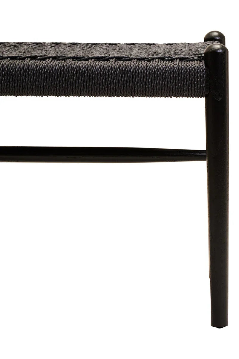 Black woven bench seat with solid wood legs and visible textured detail