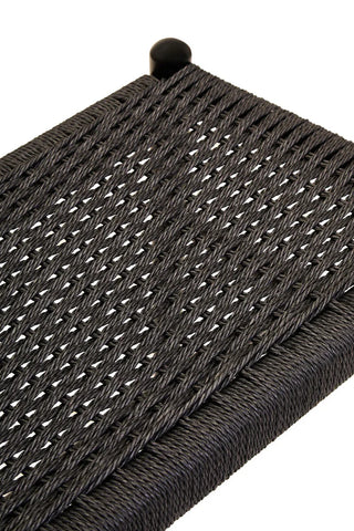 Closeup of black woven rattan outdoor furniture seat with durable rope detailing