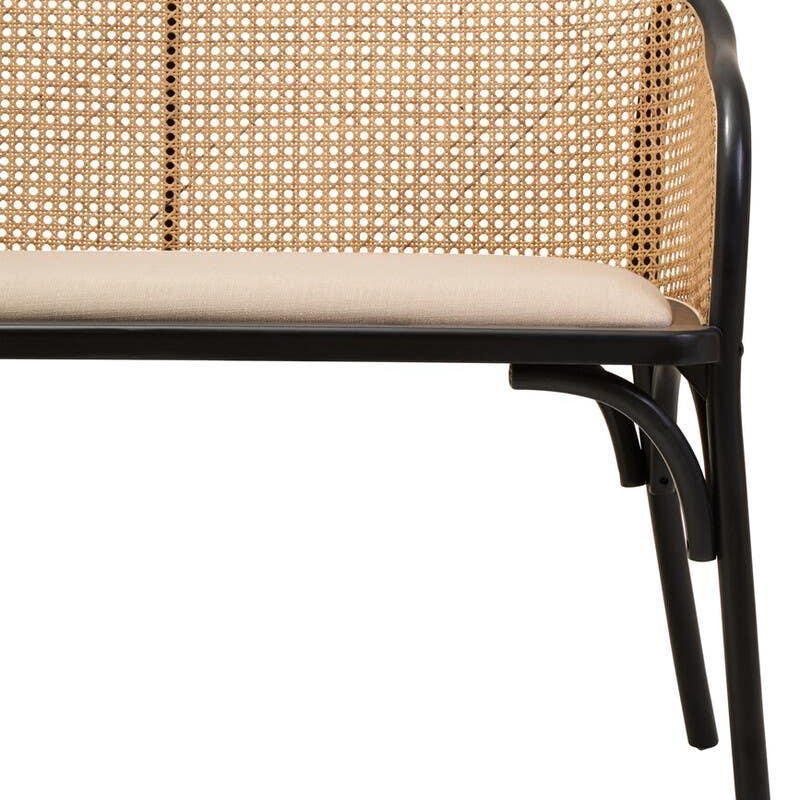 Rattan back bench with black frame and beige cushion, partial side view