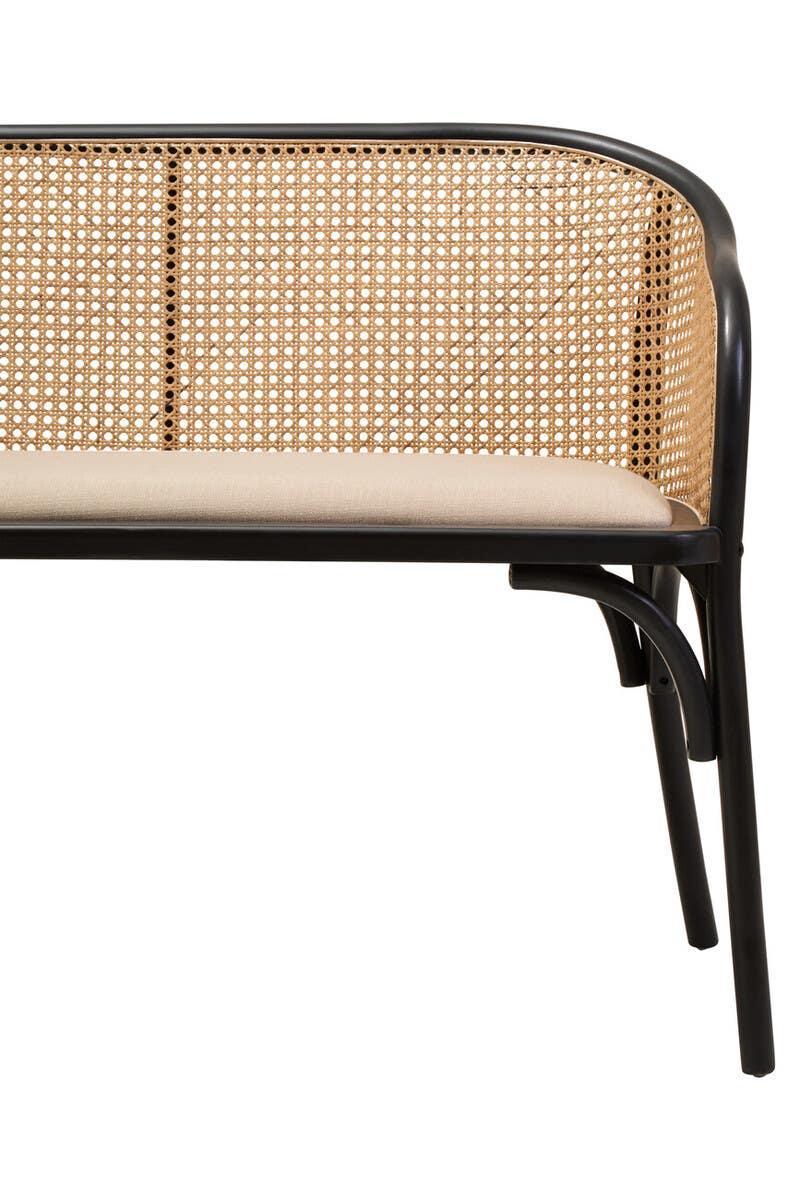 Rattan back bench with black frame and beige cushion, partial side view