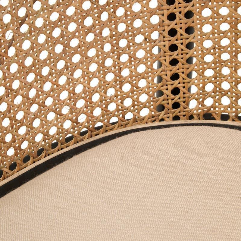 Close-up of rattan chair backrest with woven cane and beige fabric seat
