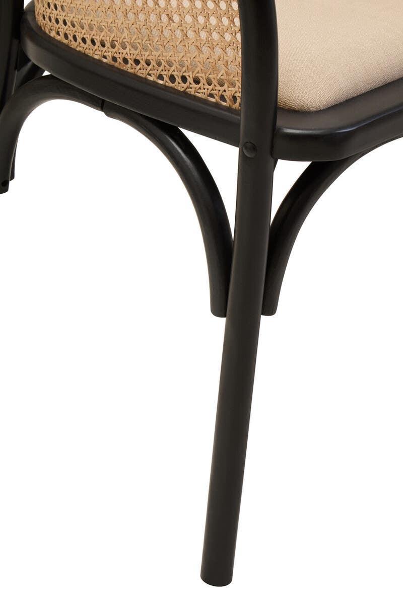 Close view rattan dining chair with black metal legs and beige cushion