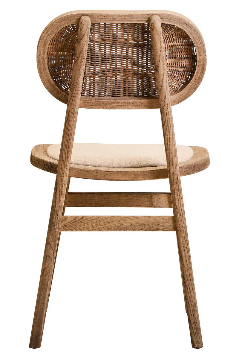 Back view of wooden dining chair with woven rattan backrest and cushioned seat