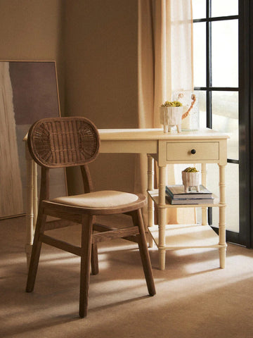 Wooden desk and rattan chair set by window with books and plant decor