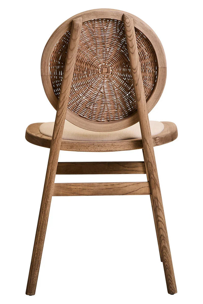Wood dining chair with woven rattan round backrest and beige cushioned seat, rear view