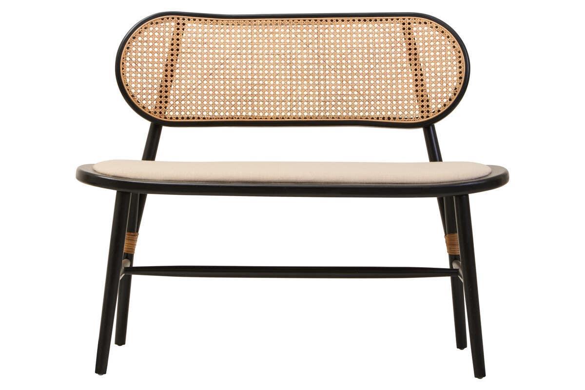 Rattan bench with rounded cane backrest, black frame, and beige cushioned seat