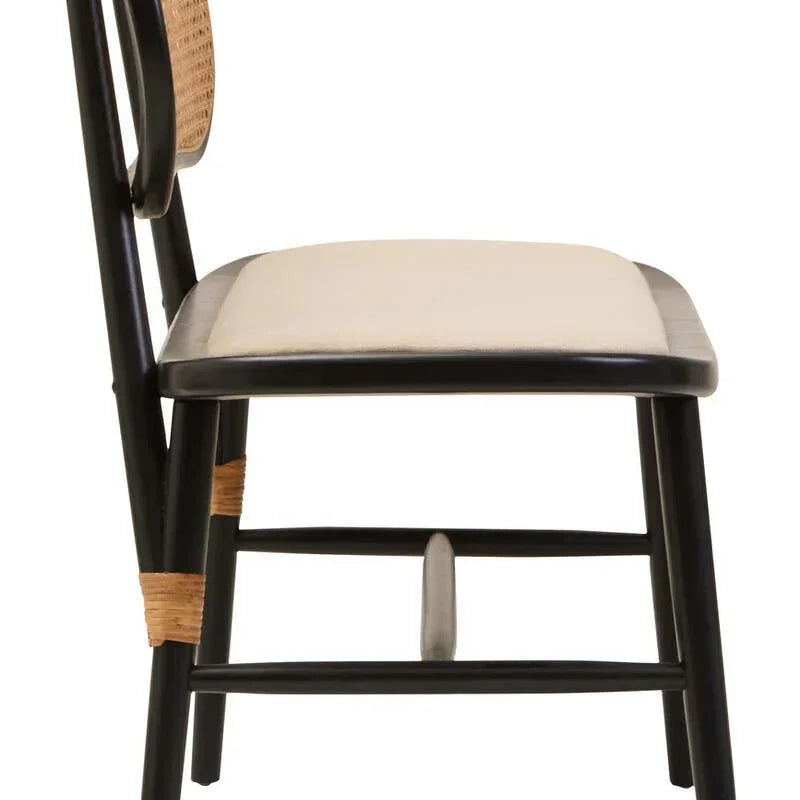 Side view black dining chair with beige cushioned seat and rattan backrest