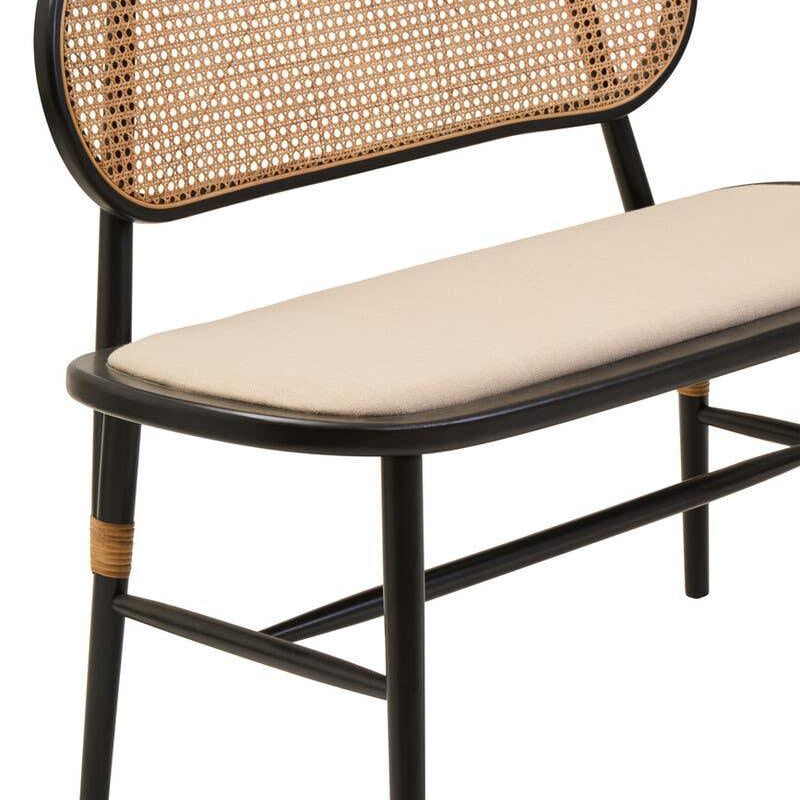 Black frame bench with rattan backrest and beige cushioned seat