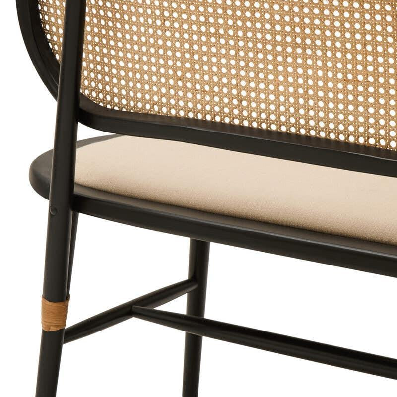 Rattan bench with black wood frame and beige upholstered seat, close-up of backrest