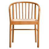 Light wood dining chair with spindle back and woven seat, front view