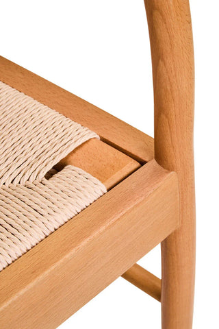 Closeup of natural wood dining chair with woven rope seat detail
