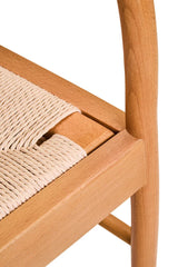 Closeup of natural wood dining chair with woven rope seat detail