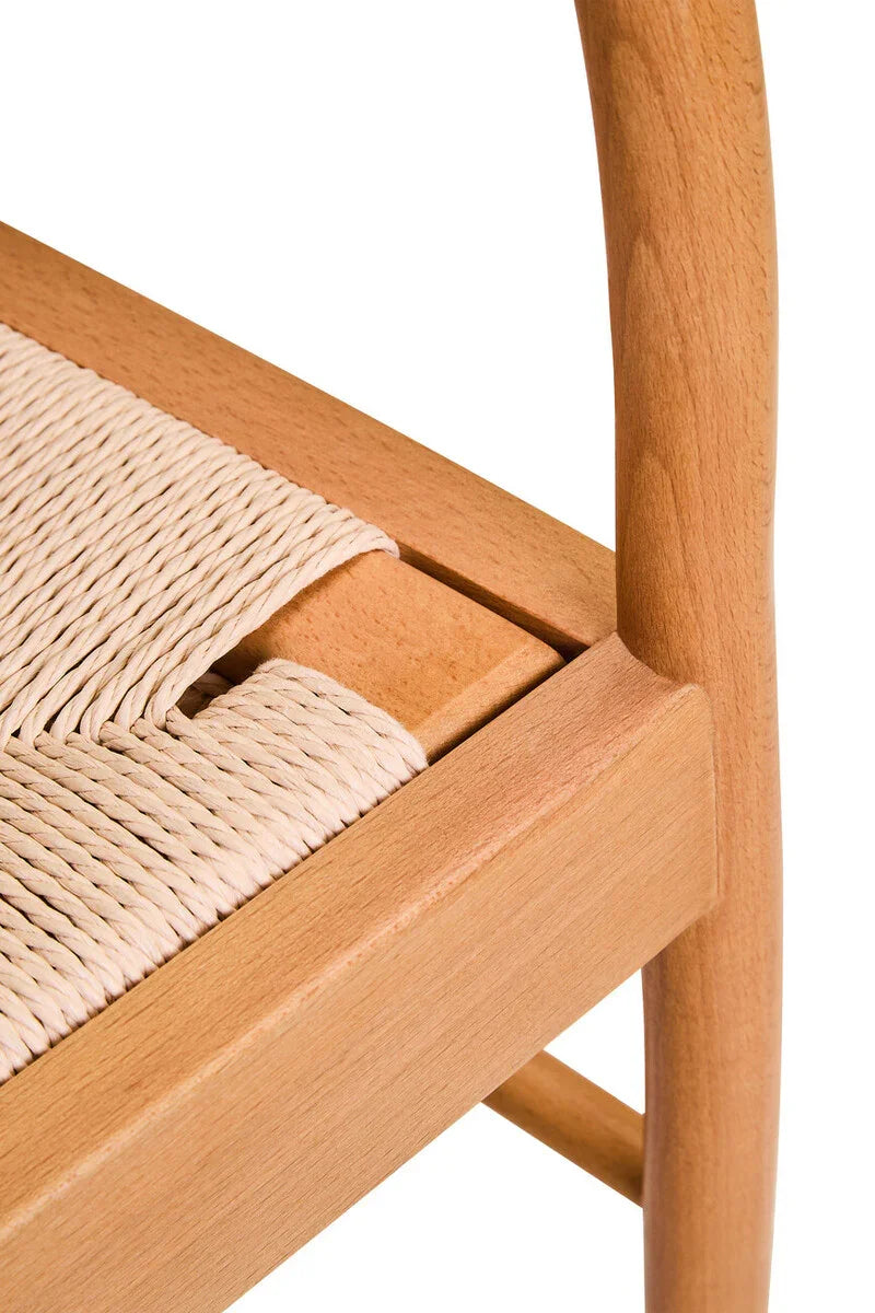 Closeup of natural wood dining chair with woven rope seat detail