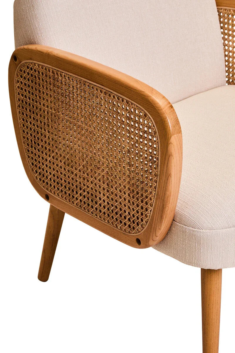 Beige fabric armchair with wooden frame and cane webbing detail on the armrest