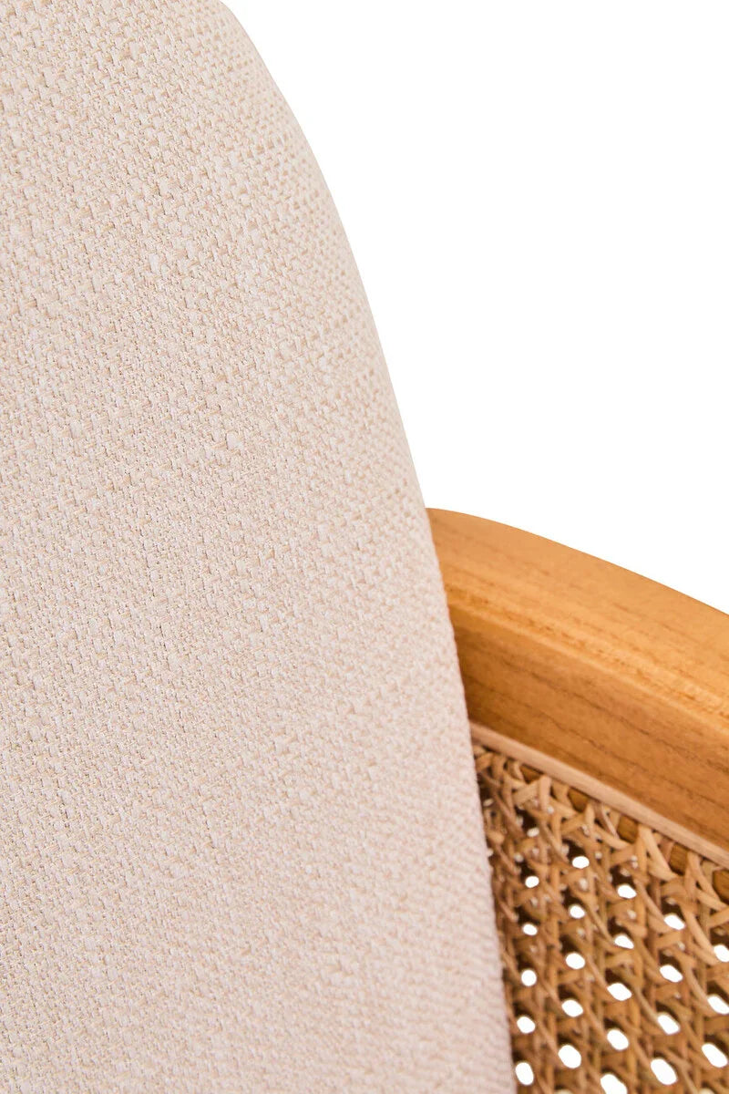 Close-up of beige fabric armchair backrest with wooden frame and woven cane panel