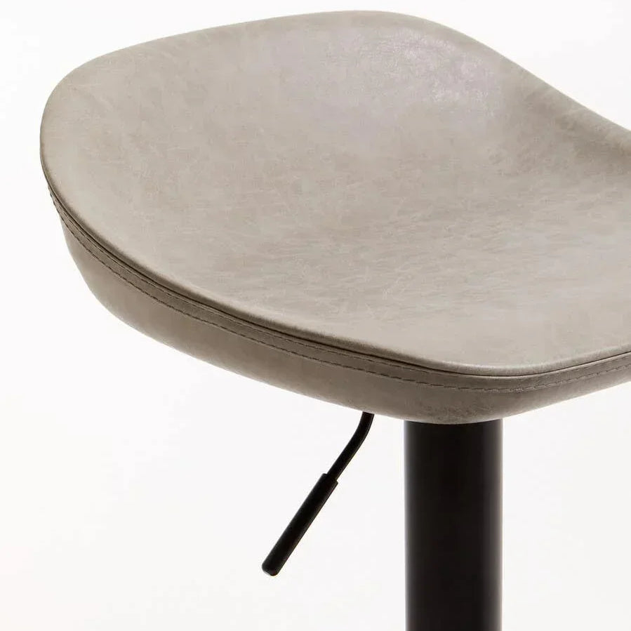 Close-up of grey faux leather bar stool seat with black adjustable metal base